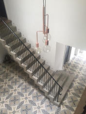 Stepped soffit stair with metal balustrade