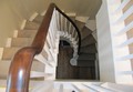 stairs with wooden spindles and carpet to treads