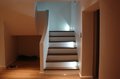 stairs finished with wood on treads and risers and LED lights on every third tread