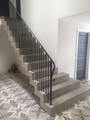Lovely finished, polisihed concrete stair with metal balustrade.
